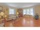 Inviting living room featuring hardwood floors, a comfortable sofa, and natural light enhancing the cozy atmosphere at 412 43Rd Ave. N, Myrtle Beach, SC 29577