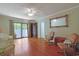 Bright living room featuring hardwood floors, a ceiling fan, and access to outdoor space at 412 43Rd Ave. N, Myrtle Beach, SC 29577