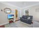 Comfortable sitting room featuring a leather sofa, a TV, and ample natural light at 412 43Rd Ave. N, Myrtle Beach, SC 29577