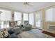 Bright sunroom with multiple windows, cozy armchairs, and access to outdoor space at 412 43Rd Ave. N, Myrtle Beach, SC 29577