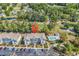 Aerial view of condo building with a pool, surrounded by trees and a golf course at 4430 Eastport Blvd. # L15, Little River, SC 29566