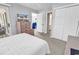 Bedroom featuring a TV, dresser, doorway to the bathroom, and doorway to a screened porch at 4430 Eastport Blvd. # L15, Little River, SC 29566