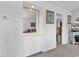 Hallway featuring a built-in cabinet and mirror with views of the living room and an adjacent bedroom at 4430 Eastport Blvd. # L15, Little River, SC 29566
