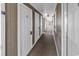 Condo hallway featuring unit doors, carpeted floor, and neutral-colored walls with an exit sign at 4430 Eastport Blvd. # L15, Little River, SC 29566