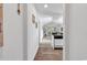 Hallway with wood flooring, leading to living area featuring an open layout and lots of natural light at 4430 Eastport Blvd. # L15, Little River, SC 29566