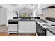 Bright kitchen boasts white cabinetry, a black countertop, and modern appliances for a functional and stylish cooking space at 4430 Eastport Blvd. # L15, Little River, SC 29566