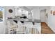 Stylish kitchen bar with seating, complemented by modern white cabinetry, countertops, and appliances for a great gathering spot at 4430 Eastport Blvd. # L15, Little River, SC 29566
