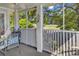 View of a screened porch with chairs, a table, and view of the greenery at 4430 Eastport Blvd. # L15, Little River, SC 29566