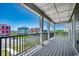 Spacious outdoor balcony featuring composite decking, white support columns, and beautiful neighborhood views at 468 Saint Julian Ln., Myrtle Beach, SC 29579