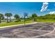 Outdoor basketball court surrounded by trees, grass, and a lake view at 468 Saint Julian Ln., Myrtle Beach, SC 29579