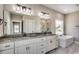 Elegant bathroom with double vanity, granite countertop, soaking tub, decorative lights, and modern fixtures at 468 Saint Julian Ln., Myrtle Beach, SC 29579