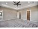 Bright bedroom boasts plush carpeting, a tray ceiling, and access to a walk-in closet and en-suite bathroom at 468 Saint Julian Ln., Myrtle Beach, SC 29579