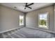 Bedroom featuring neutral carpeting, base molding, updated ceiling fan and two large windows at 468 Saint Julian Ln., Myrtle Beach, SC 29579