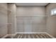 Empty walk-in closet featuring carpet flooring, a single window, and built-in wire shelving for optimal organization at 468 Saint Julian Ln., Myrtle Beach, SC 29579
