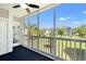 Screened-in balcony with scenic views of manicured lawns and neighboring buildings at 4683 Wild Iris Dr. # 204, Myrtle Beach, SC 29577