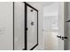 Modern bathroom features a sleek glass shower with black trim and door at 4683 Wild Iris Dr. # 204, Myrtle Beach, SC 29577