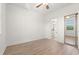 Bright bedroom with hardwood floors, ceiling fan, and an en-suite bathroom at 4683 Wild Iris Dr. # 204, Myrtle Beach, SC 29577