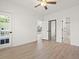 Bright bedroom featuring light wood floors, a sliding door to the balcony, and ensuite bathroom at 4683 Wild Iris Dr. # 204, Myrtle Beach, SC 29577