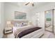 Bright bedroom with hardwood floors, ceiling fan, and an en-suite bathroom at 4683 Wild Iris Dr. # 204, Myrtle Beach, SC 29577