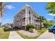 Exterior elevation of a multi-story condo building with private balconies and landscaped grounds at 4683 Wild Iris Dr. # 204, Myrtle Beach, SC 29577