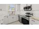 Modern white kitchen featuring stainless steel appliances, quartz countertops, and subway tile backsplash at 4683 Wild Iris Dr. # 204, Myrtle Beach, SC 29577