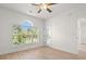 Bright living room featuring an arched window with a view of mature trees at 4683 Wild Iris Dr. # 204, Myrtle Beach, SC 29577