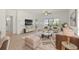 Staged bright living room featuring light wood floors, comfortable seating, and a view to the bedroom at 4683 Wild Iris Dr. # 204, Myrtle Beach, SC 29577