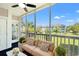 Screened in patio showing an outdoor seating area and views of the neighborhood at 4683 Wild Iris Dr. # 204, Myrtle Beach, SC 29577