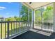Screened-in porch with a lovely view of green space and mature trees at 4683 Wild Iris Dr. # 204, Myrtle Beach, SC 29577