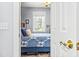Bedroom featuring a window, closet, and door to bathroom with a comfortable bed and decor at 4787 Wild Iris Dr. # 101, Myrtle Beach, SC 29577