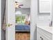 View into a blue bedroom with a white trimmed door and a bathroom vanity to the right at 4787 Wild Iris Dr. # 101, Myrtle Beach, SC 29577