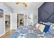 Bedroom featuring doorways into a walk-in closet and en-suite bathroom; hardwood floors at 4787 Wild Iris Dr. # 101, Myrtle Beach, SC 29577