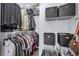 Well-organized walk-in closet with ample hanging space and storage boxes for clothing and accessories at 4787 Wild Iris Dr. # 101, Myrtle Beach, SC 29577