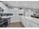 Bright kitchen featuring white cabinets, stainless steel appliances, tile backsplash, and a large arched window at 4787 Wild Iris Dr. # 101, Myrtle Beach, SC 29577