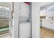 Convenient stacked washer and dryer next to the exit door and a kitchen at 4787 Wild Iris Dr. # 101, Myrtle Beach, SC 29577