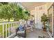 Cozy covered patio with comfortable seating, hanging plants, and scenic outdoor views at 4787 Wild Iris Dr. # 101, Myrtle Beach, SC 29577