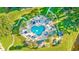 Aerial view of a heart-shaped pool, surrounded by lounge chairs, umbrellas, and lush landscaping at 4787 Wild Iris Dr. # 101, Myrtle Beach, SC 29577