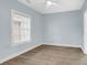 Bedroom with wood floors, large window, and light blue walls at 4878 Dahlia Ct. # 104, Myrtle Beach, SC 29577