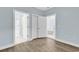 Light-blue bedroom featuring wood-look flooring, a closet, and two doorways at 4878 Dahlia Ct. # 104, Myrtle Beach, SC 29577