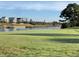 Golf course with waterfront homes in the background on a sunny day at 4878 Dahlia Ct. # 104, Myrtle Beach, SC 29577