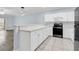 Kitchen with white cabinets and appliances, gray countertops, and tile floor at 4878 Dahlia Ct. # 104, Myrtle Beach, SC 29577