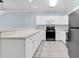 Kitchen with white cabinets and appliances, gray countertops, and tile floor at 4878 Dahlia Ct. # 104, Myrtle Beach, SC 29577