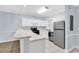 Bright kitchen features white cabinets, stainless steel appliances, and tile flooring at 4878 Dahlia Ct. # 104, Myrtle Beach, SC 29577
