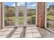 Sun room featuring brick accent wall and floor to ceiling windows with views of the outdoor space at 4878 Dahlia Ct. # 104, Myrtle Beach, SC 29577