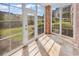 Sun room featuring brick accent wall and floor to ceiling windows with views of the outdoor space at 4878 Dahlia Ct. # 104, Myrtle Beach, SC 29577