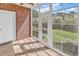 Sun room featuring brick accent wall and floor to ceiling windows with views of the outdoor space at 4878 Dahlia Ct. # 104, Myrtle Beach, SC 29577