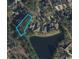 Aerial view of a property surrounded by mature trees and a tranquil pond at 4932 South Island Dr., North Myrtle Beach, SC 29582