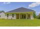 Backyard view of a single story home with a covered patio and well-maintained lawn at 4932 South Island Dr., North Myrtle Beach, SC 29582