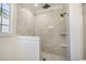 New bathroom featuring marble walk-in shower with black fixtures and white wall and floor tiling at 4932 South Island Dr., North Myrtle Beach, SC 29582