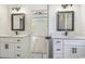Dual sink bathroom vanity with black hardware opens to a bedroom, creating a bright and modern space at 4932 South Island Dr., North Myrtle Beach, SC 29582